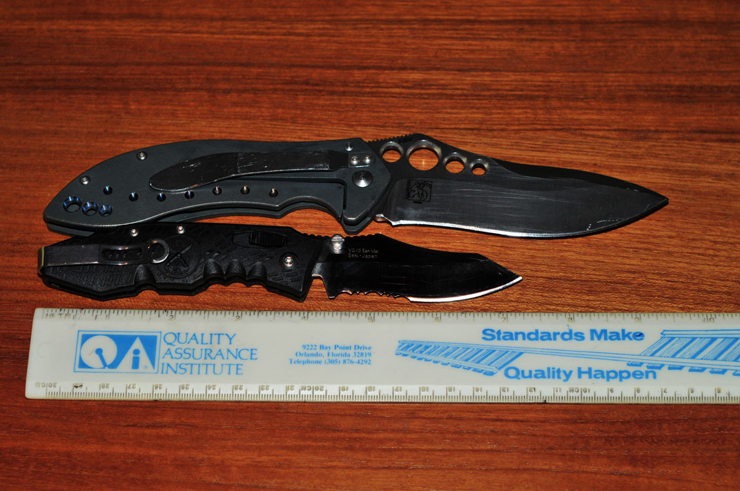 SOG TK02 (bottom, blade is not black - just the reflection) vs Benchmade 630