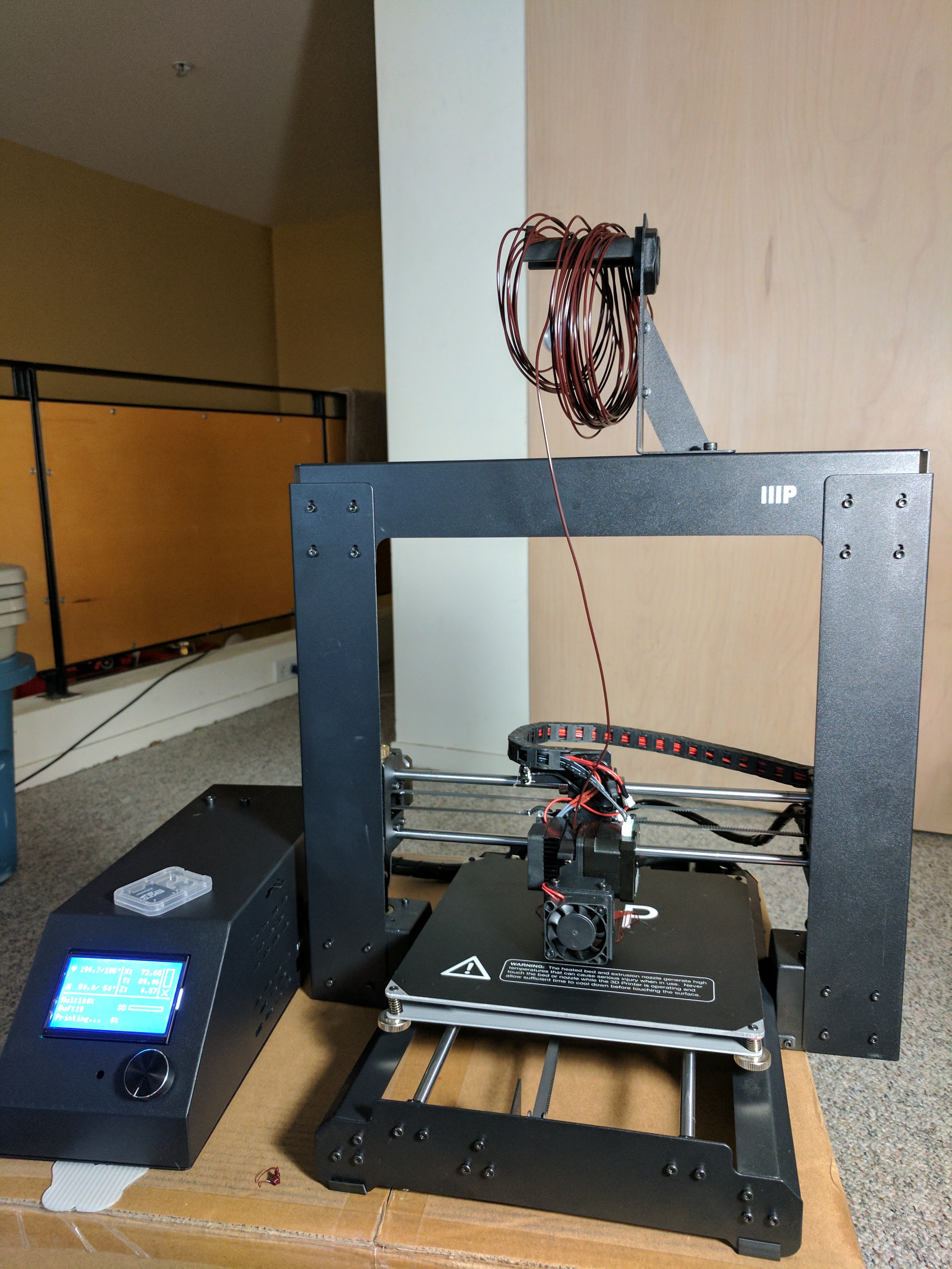 This is my Monoprice Maker Select v2 after assembly and printing its first job. Note: A carboard box is a terribly BAD platform for 3D Printing.
